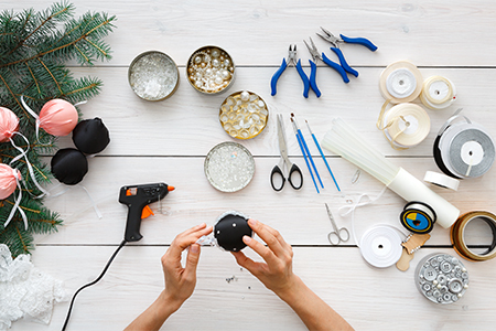 Top view of leisure, tools for creating holiday decorations, pliers, glue gun and scissors