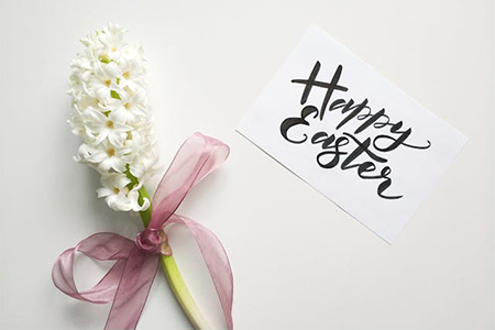 white paper sign wishing everyone a joyful 'Happy Easter!'