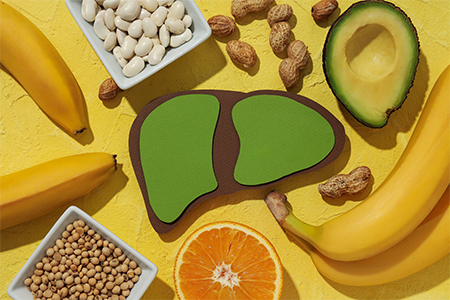 Paper liver, nuts, fruits and beans on yellow background, top view