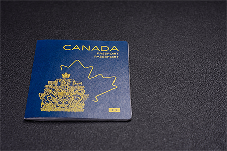 passport of a citizen of Canada on a dark concrete background