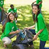 A vibrant community clean-up day brings together volunteers clad in green shirts, joyfully collectin