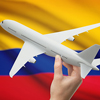 Airplane in hand with national flag on background - Colombia