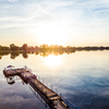 aerial view of pier on a lake during fantastic beautiful sunset in countryside
