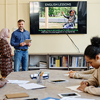 multi-ethnic group attending English language classes doing tasks during lesson