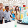 Kids having fun watching an experiment at a science centre