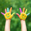Child hands in paints a smile