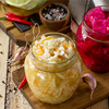 Homemade Sauerkraut with Carrot and Salad Cabbage with Beetroot on a wooden table