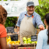people buying organic vegetables outdoors at local farmers market