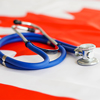 Medical stethoscope on a Canada flag. Canadian health care system