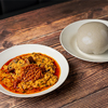 A plate of Nigerian cuisine served with pounded yam on a wooden table