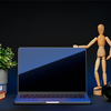 Open laptop with wooden mannequin on table against black background
