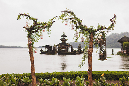 Wedding ceremony at Ulun Danu Bratan temple in Bali. Decorated with wood, flowers and vintage lamps