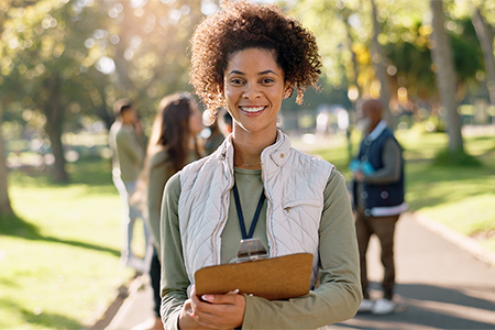Happy woman, portrait and volunteer in a university