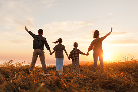 Happy family: mother, father, children son and daughter on sunset