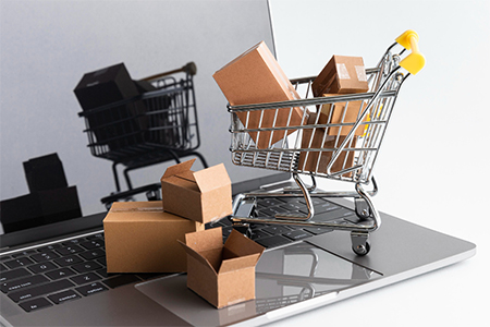 concept art: shopping cart and boxes on the laptop