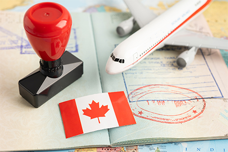 Approved Stamp visa and passport with Canada flag document to immigration at airport in country