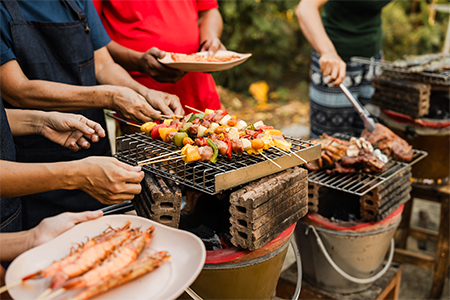 Skewers with colorful vegetables meat grilling, family friends gathering background