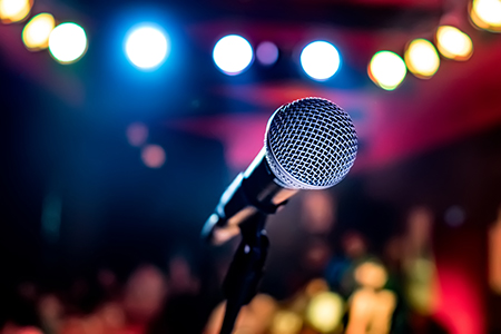 Microphone on stage against a background of auditorium