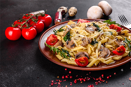 Pasta fettuccine with Alfredo sauce in wooden plate
