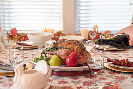 roasted turkey on a platter garnished with fresh herbs and fruit