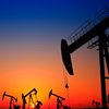 The oil pump, industrial equipment, on the background of the setting sun