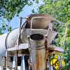 Cement truck mixer and pouring cement concrete in the morning