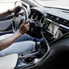 driver holding hands on steering wheel
