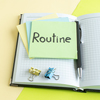 front view routine written note with stickers and notepads on yellow-green background college