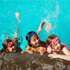 Little kids having a swimming lesson