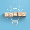 top view of glowing light bulb with goals word made of wooden blocks on blue background