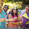 Friends dancing at music festival in park on a sunny day