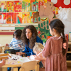 Happy encouraging teacher speaking to her class