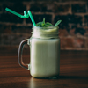 A jar of fresh tasty buttermilk on a wooden table