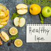 Vertical view of notebook with healthy life and collection of fresh natural organic apple slices on 