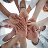 Low angle view of team members forming a hand stack