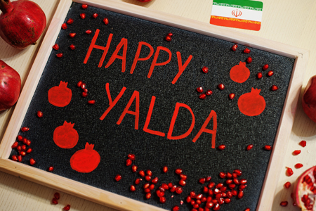 Happy Yalda night. Iranian traditional holiday. Pomegranate inscription on blackboard, flat lay.