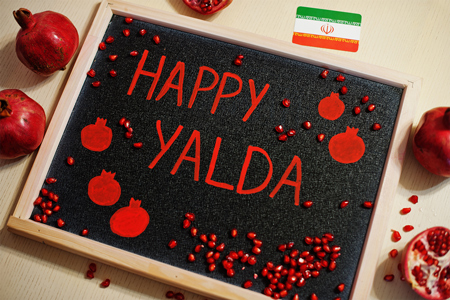 Happy Yalda night. Iranian traditional holiday. Pomegranate inscription on blackboard, flat lay.