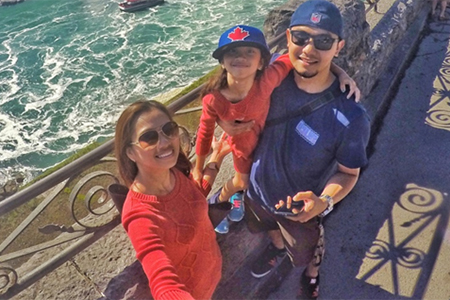 Michael, his wife and daughter taking a selfie over Niagara Falls
