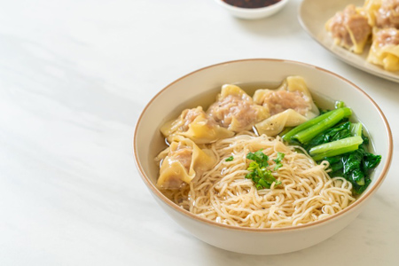 egg noodles with pork wonton soup or pork dumplings soup and vegetable - Asian food style