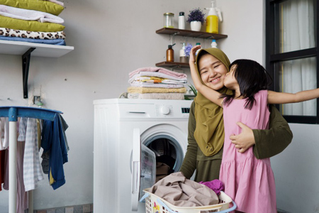 muslim asian mother and child girl little helper in laundry room