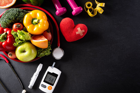 World health day and medical concept. Top view of healthy food in plate with stethoscope, red heart 