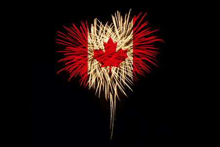fireworks in shape of heart with canada flag colours