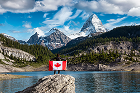 Girl Holding a Canadian National Flag, View of Og Lake in the Iconic Mt Assiniboine Provincial Park 
