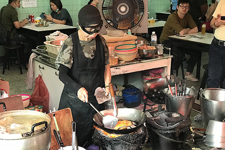 Jay Fai cooking at the shop in 2018