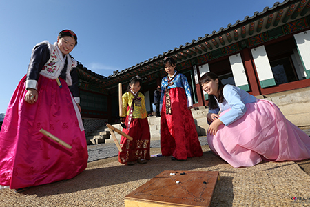 two women and two girls playing korean game