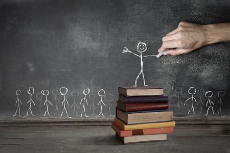 chalkboard drawing stick person standing on stack of books