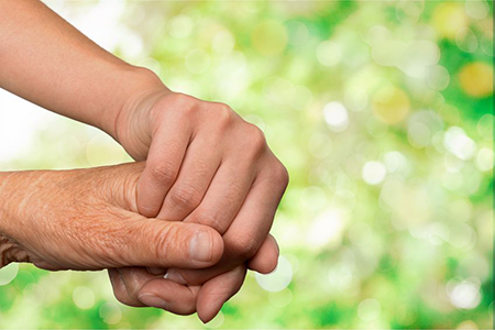 Hands of the old man and a young woman. close up.