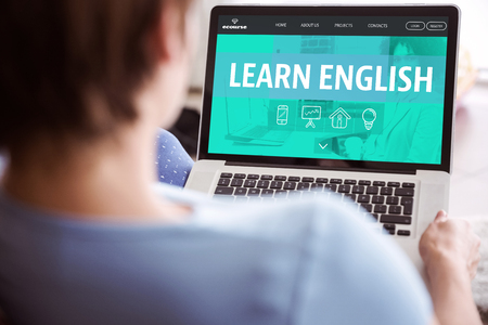 woman using her laptop against learn english interface