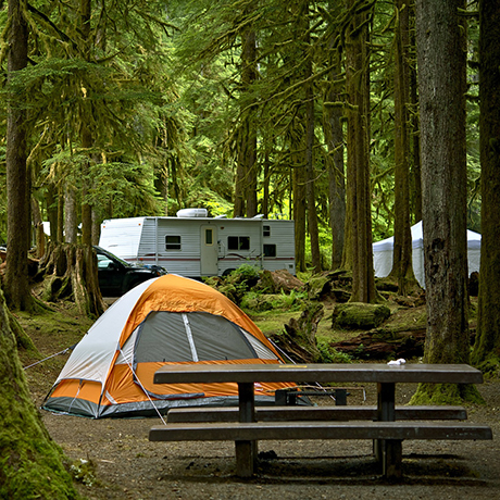 campground with tent, bench and rv
