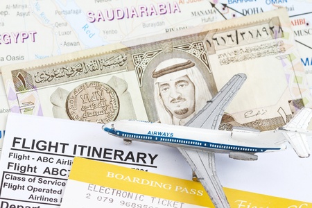 King Fahd on 1 Riyal Banknote in a map of Saudi Arabia over map, boarding pass and small toy airplan